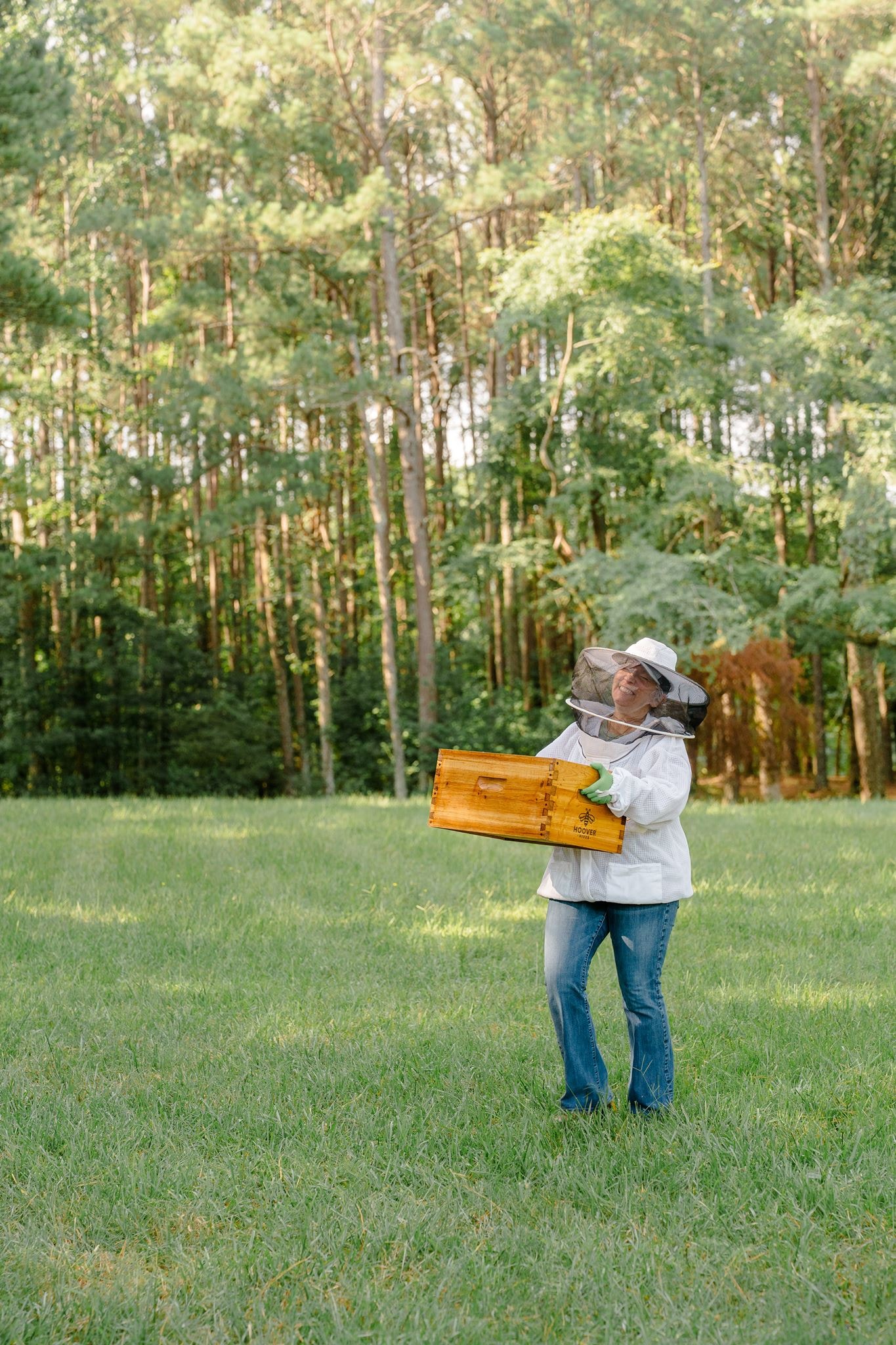 A Georgia Hive & Honey beekeeper smiling in the apiary field